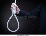 a-man-on-a-suit-holds-a-hangmans-noose-over-a-gray-background-bmp054.jpg